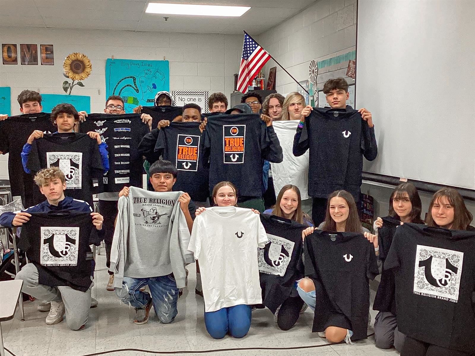 picture of students holding t-shirts